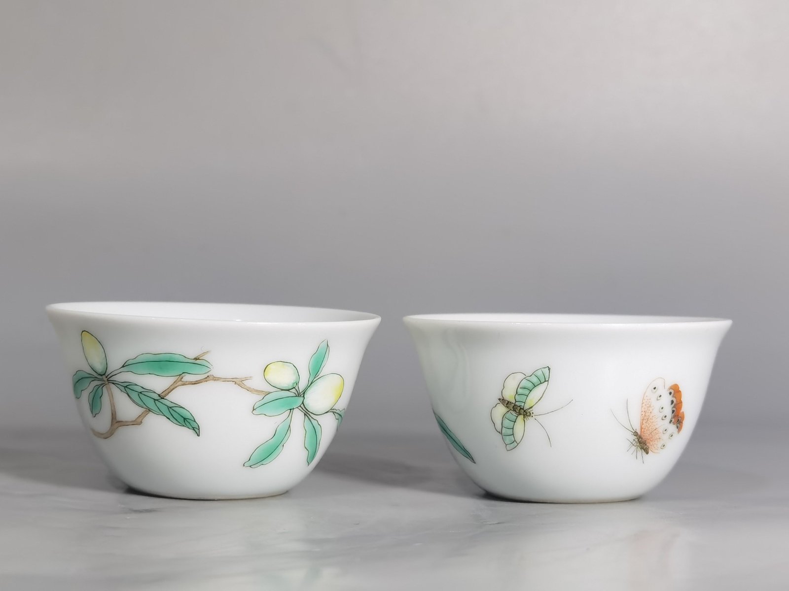 Qing Dynasty Yongzheng A pair of pastel flower and butterfly cups made during