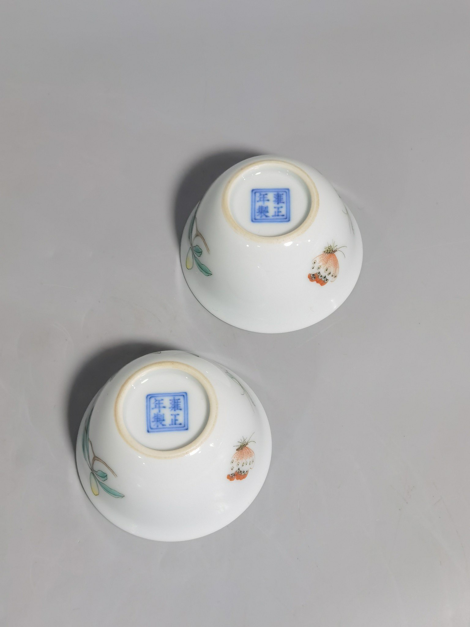Qing Dynasty Yongzheng A pair of pastel flower and butterfly cups made during