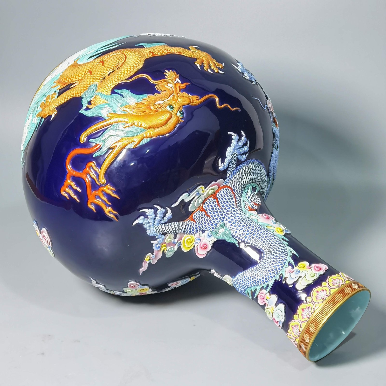 Qing Dynasty Qianlong blue glaze carving pastel gold-painted sea water dragon celestial sphere bottle