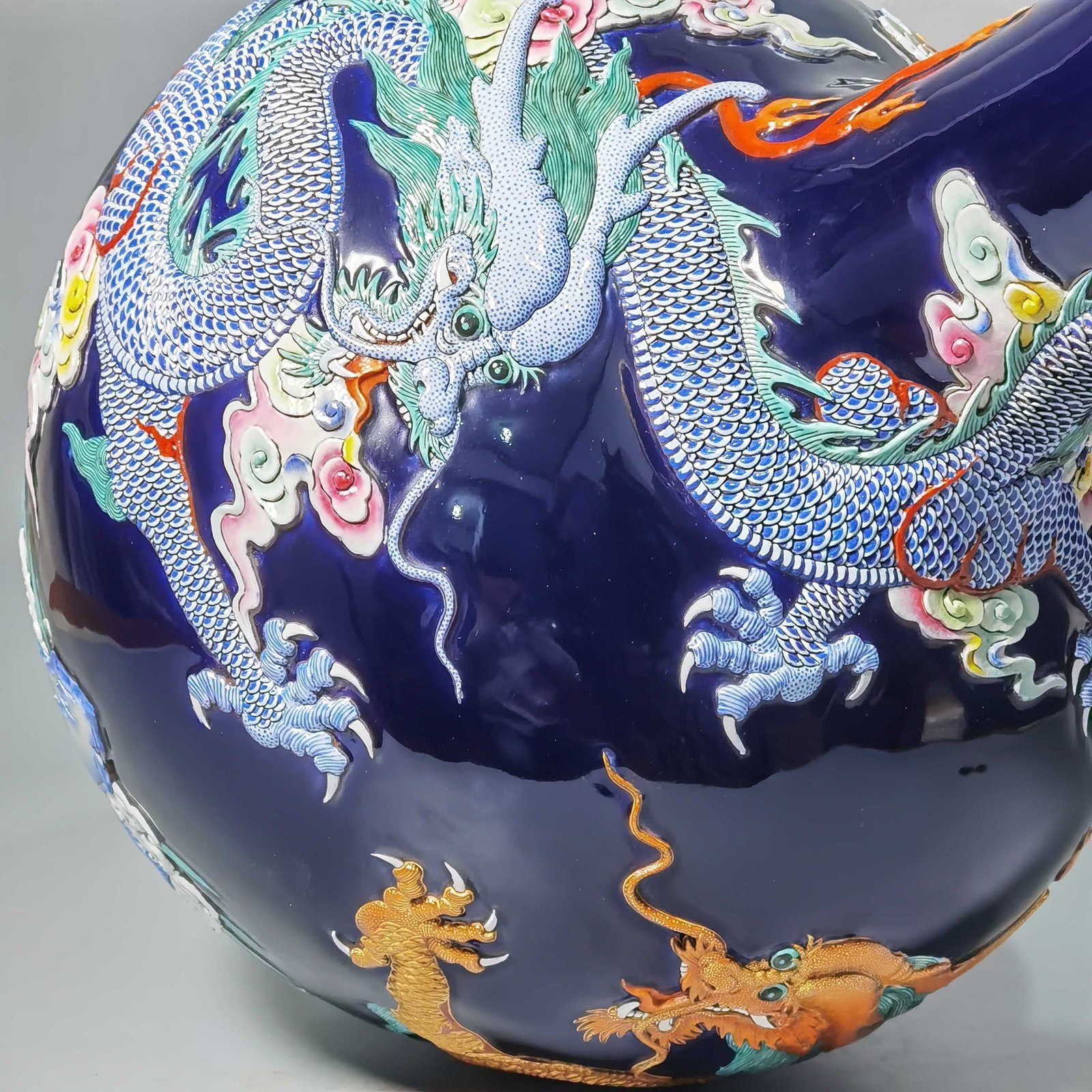 Qing Dynasty Qianlong blue glaze carving pastel gold-painted sea water dragon celestial sphere bottle
