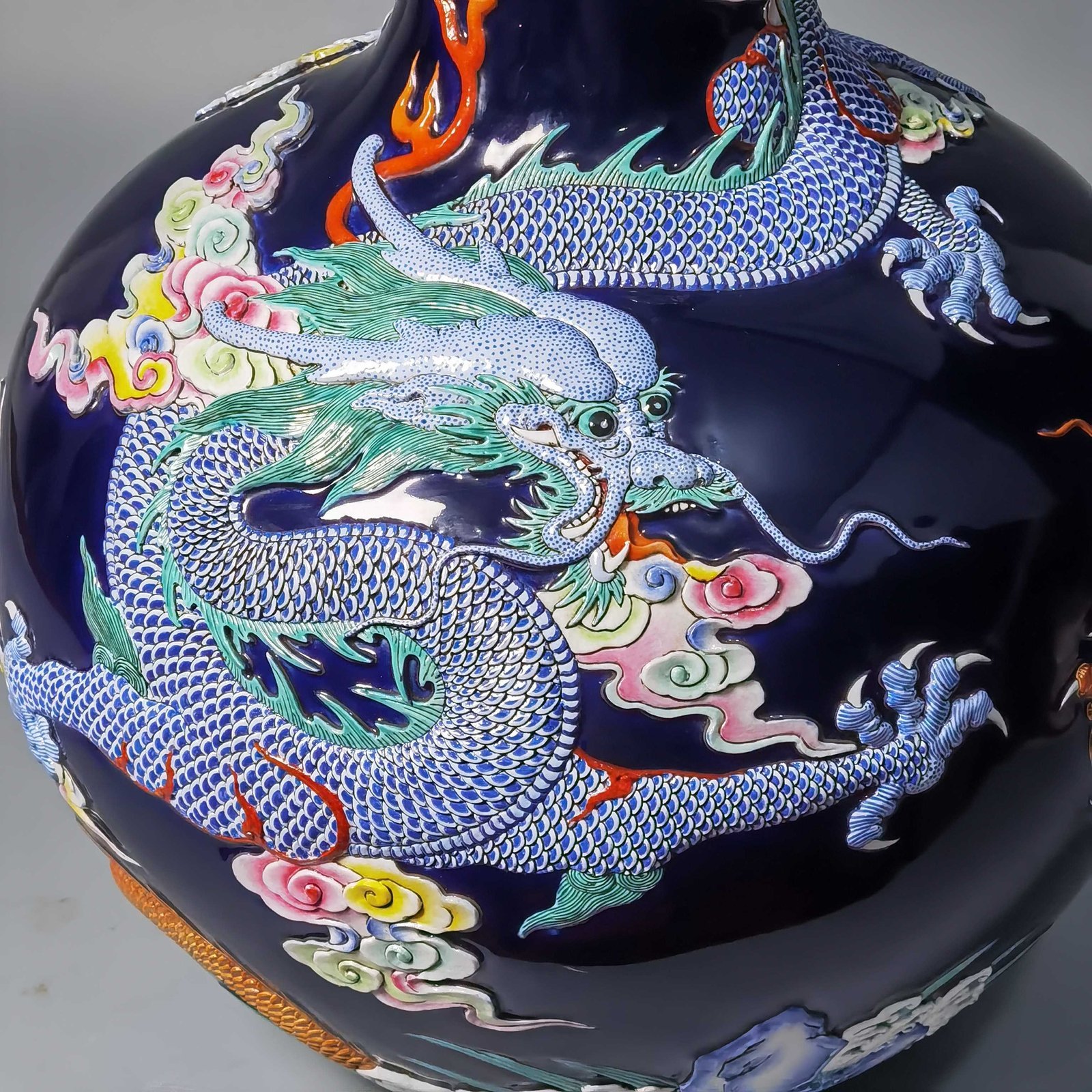 Qing Dynasty Qianlong blue glaze carving pastel gold-painted sea water dragon celestial sphere bottle
