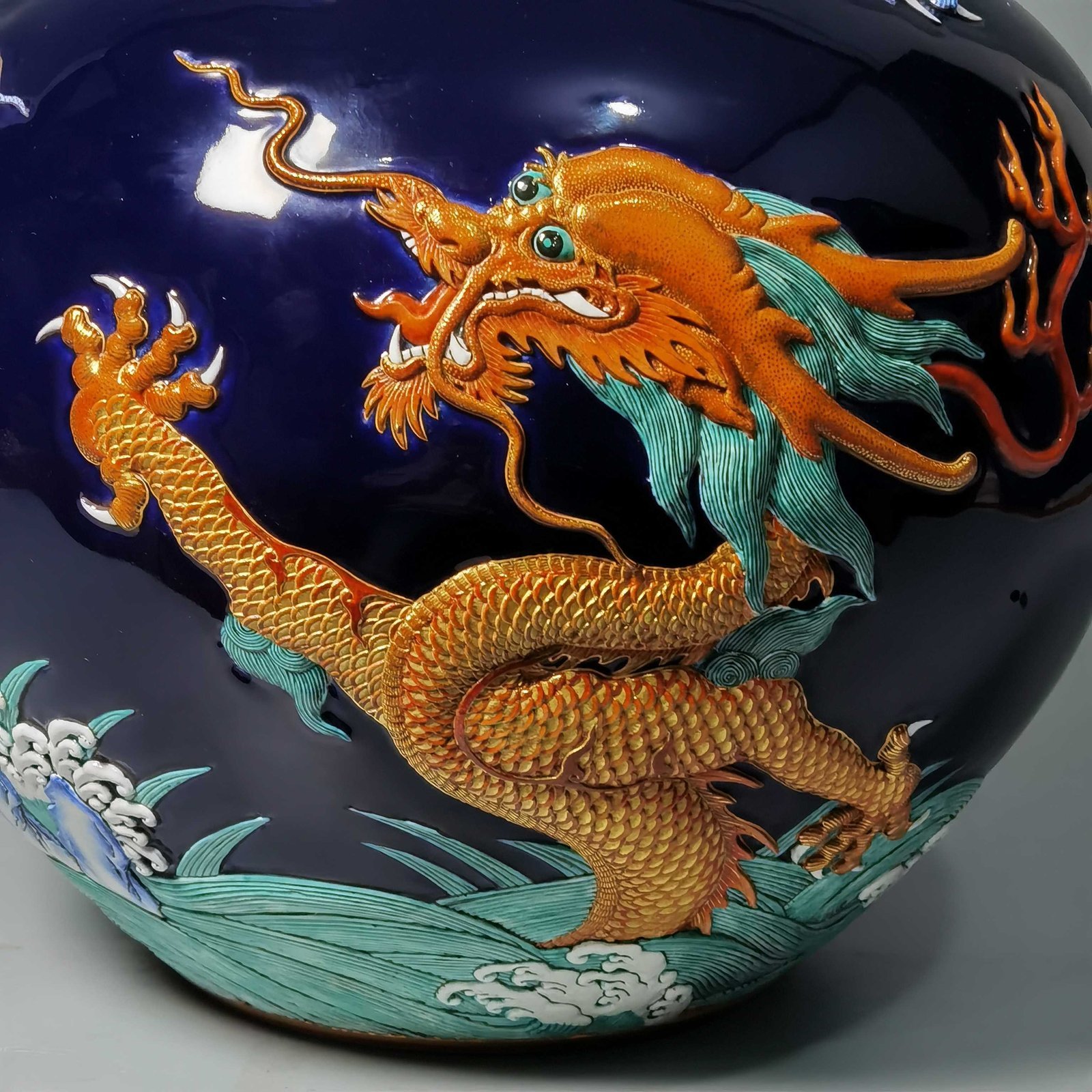 Qing Dynasty Qianlong blue glaze carving pastel gold-painted sea water dragon celestial sphere bottle