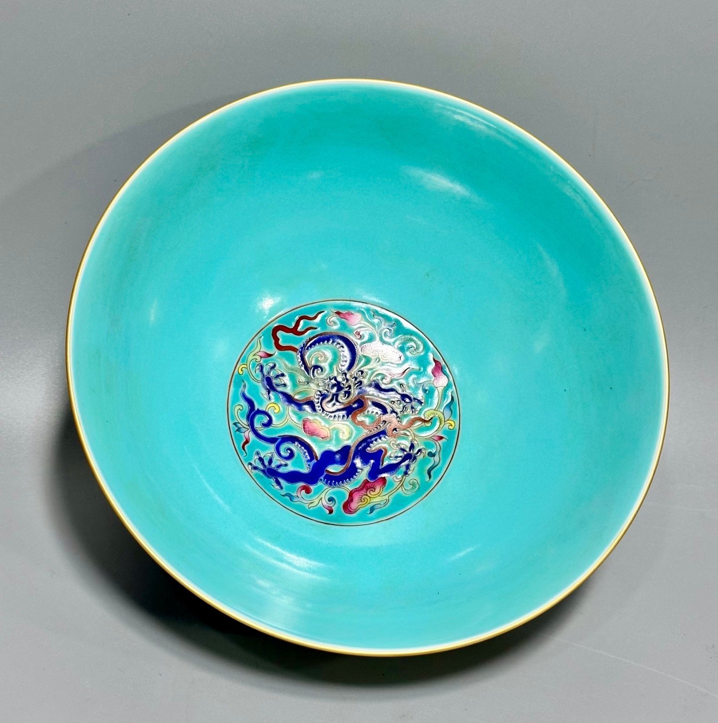 Oing Dynasty Yongzheng floral bowl with pastel grass and dragon patterns