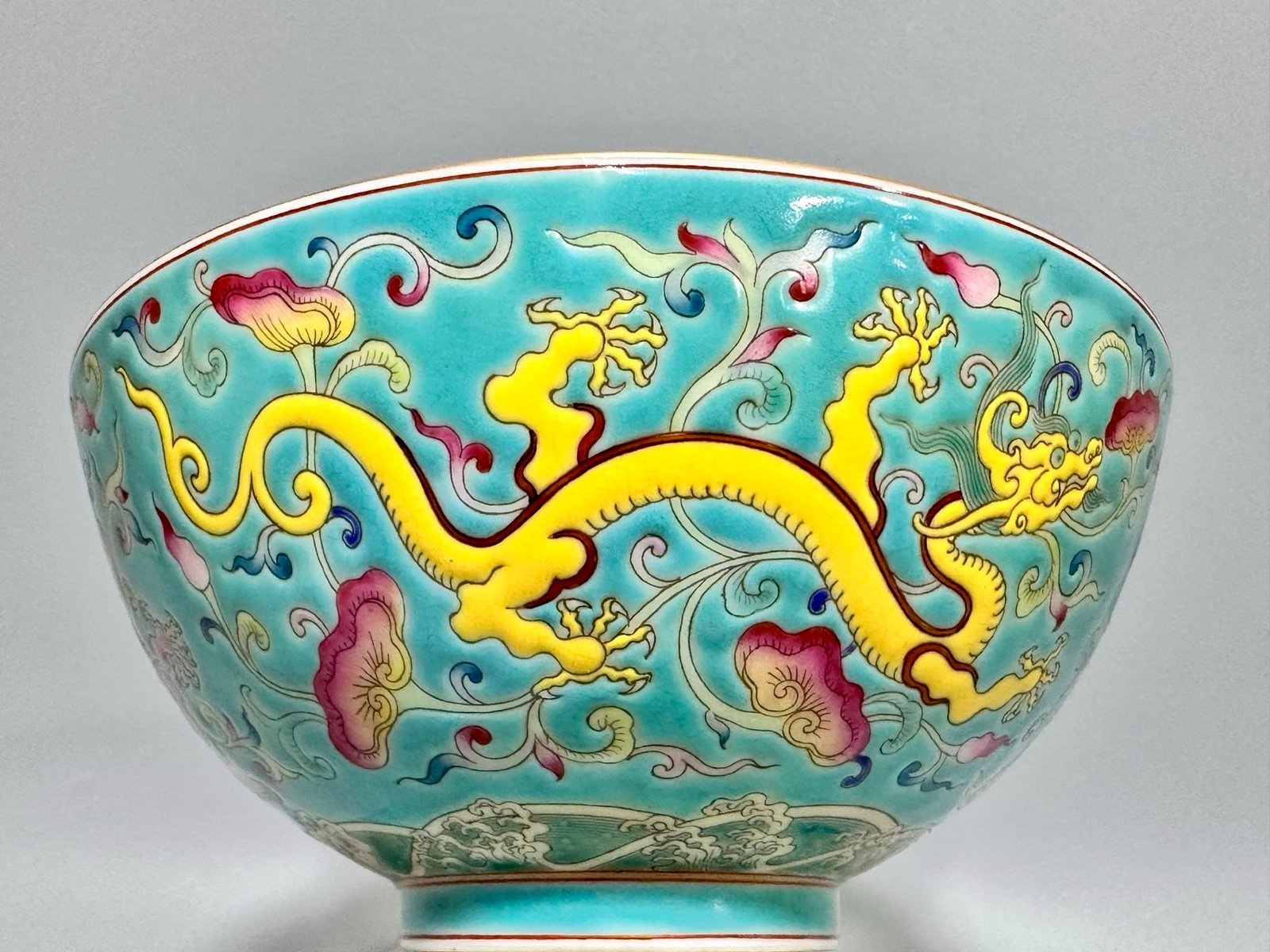 Oing Dynasty Yongzheng floral bowl with pastel grass and dragon patterns