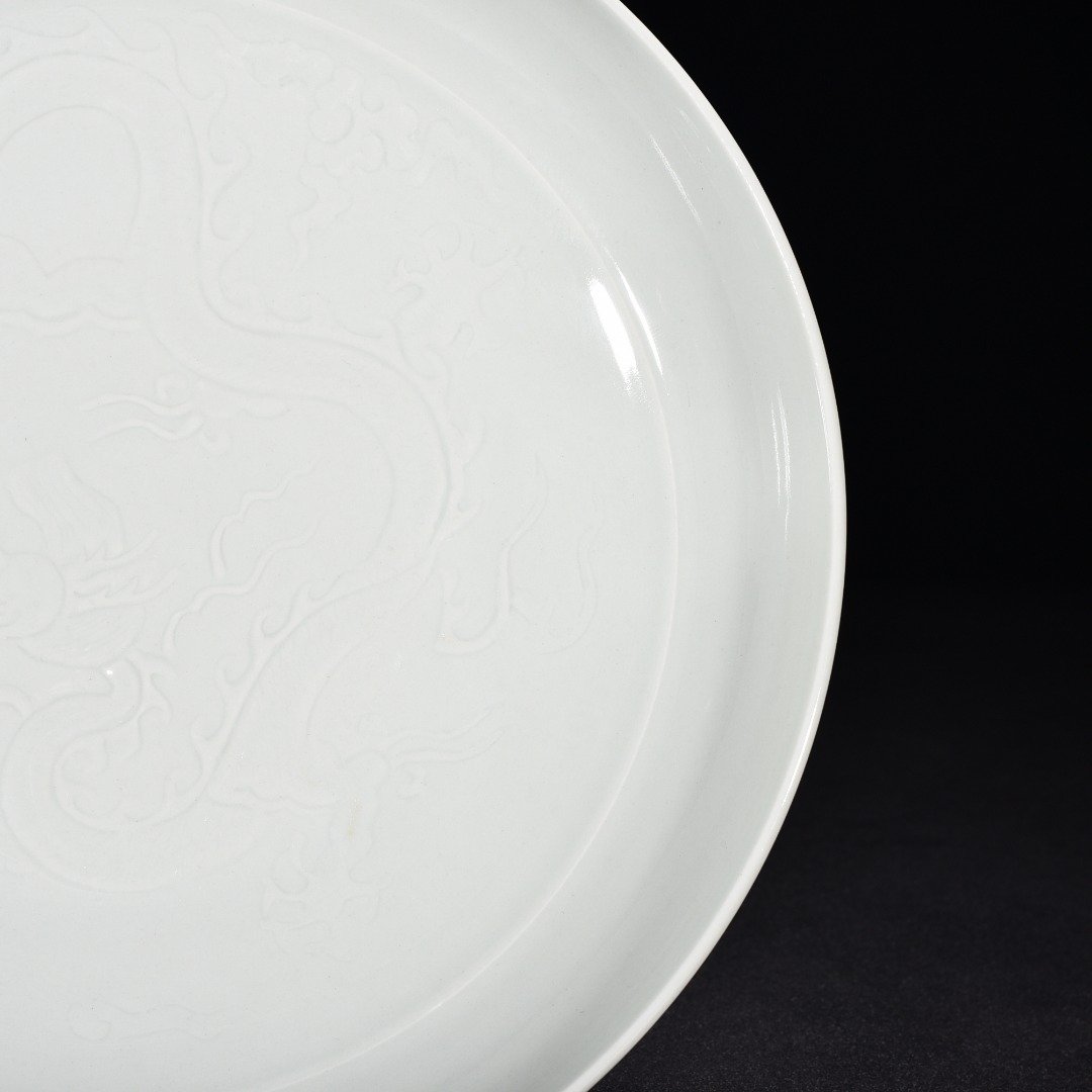 Yuan Dynasty egg white glaze engraved cloud and dragon pattern plate
