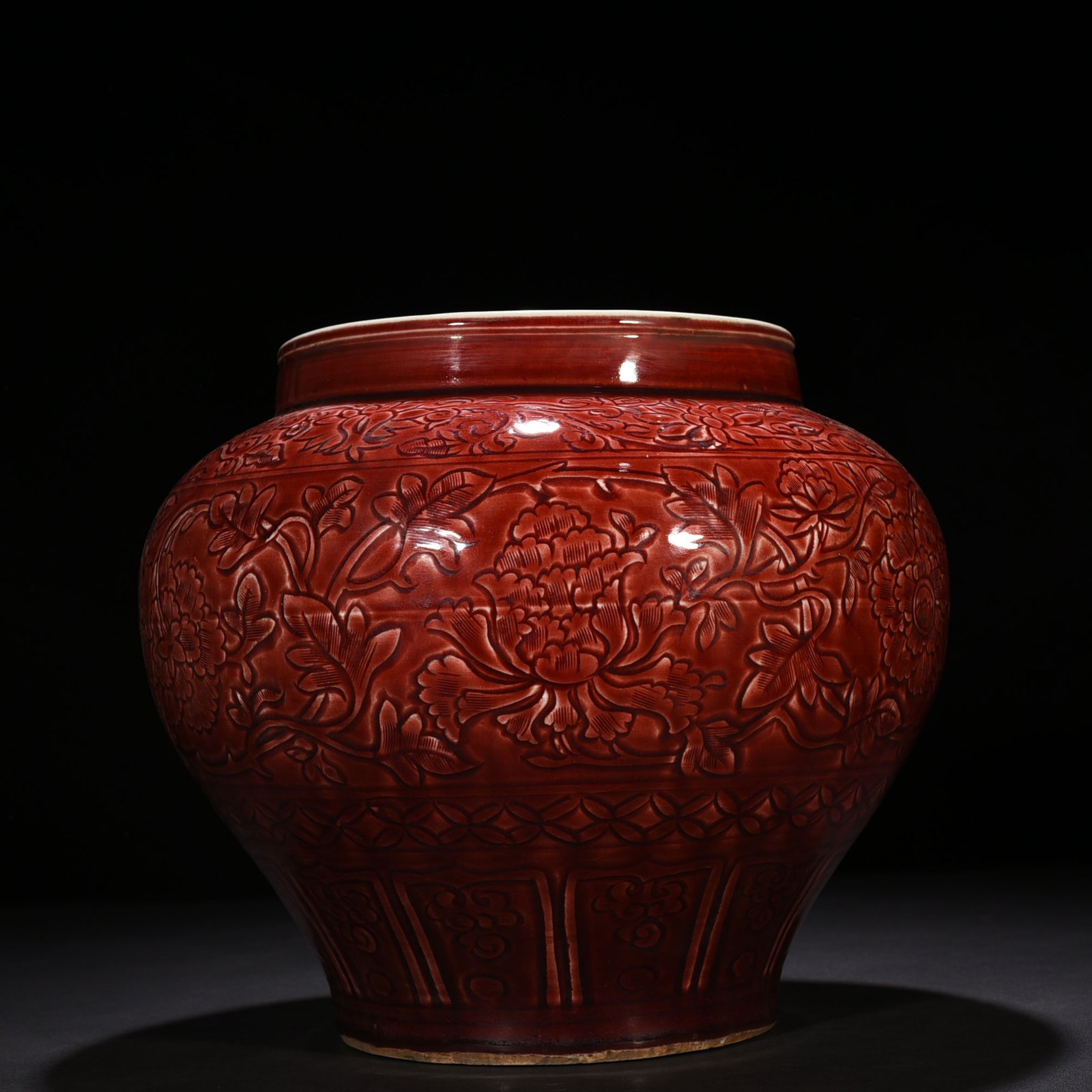 Yuan Dynasty red glaze engraved jar with peony pattern on branches