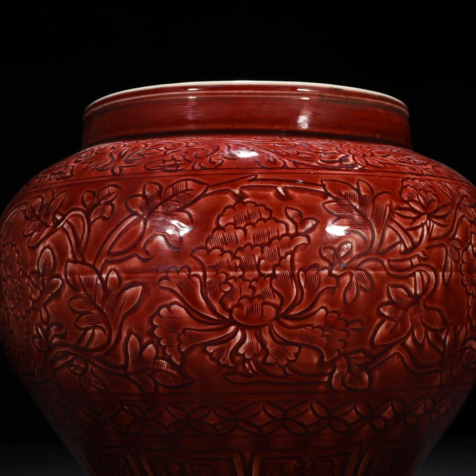 Yuan Dynasty red glaze engraved jar with peony pattern on branches