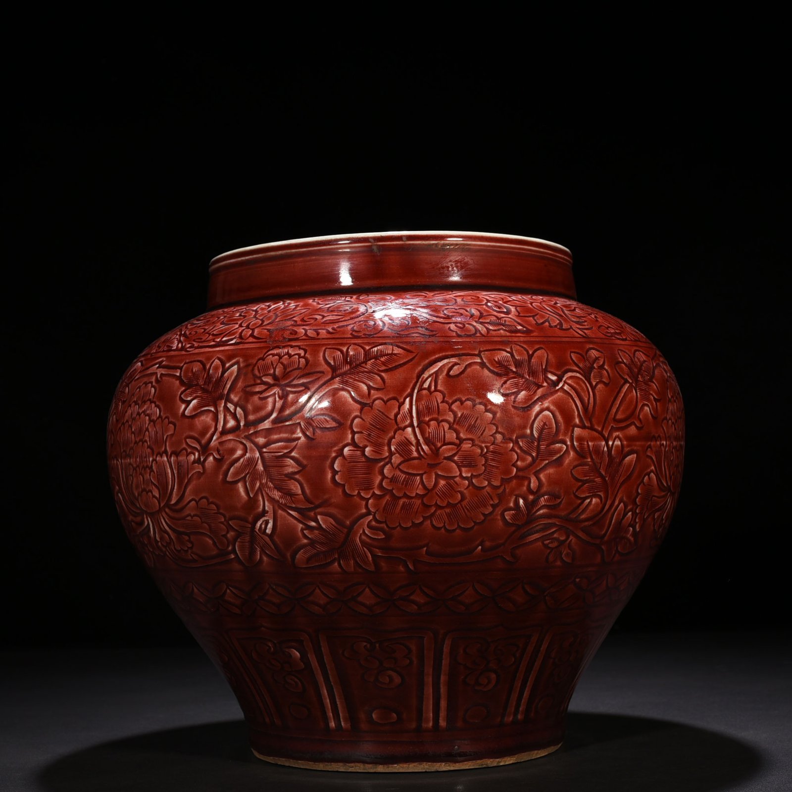 Yuan Dynasty red glaze engraved jar with peony pattern on branches