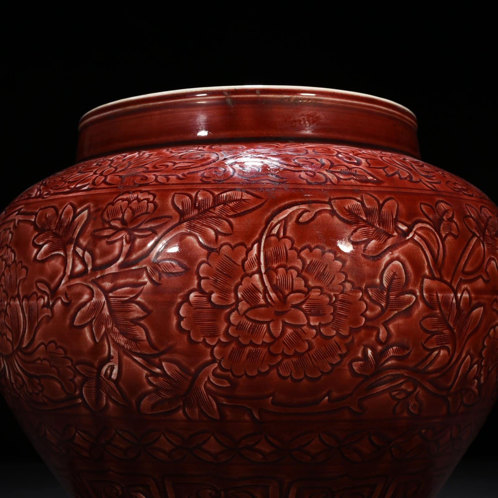 Yuan Dynasty red glaze engraved jar with peony pattern on branches