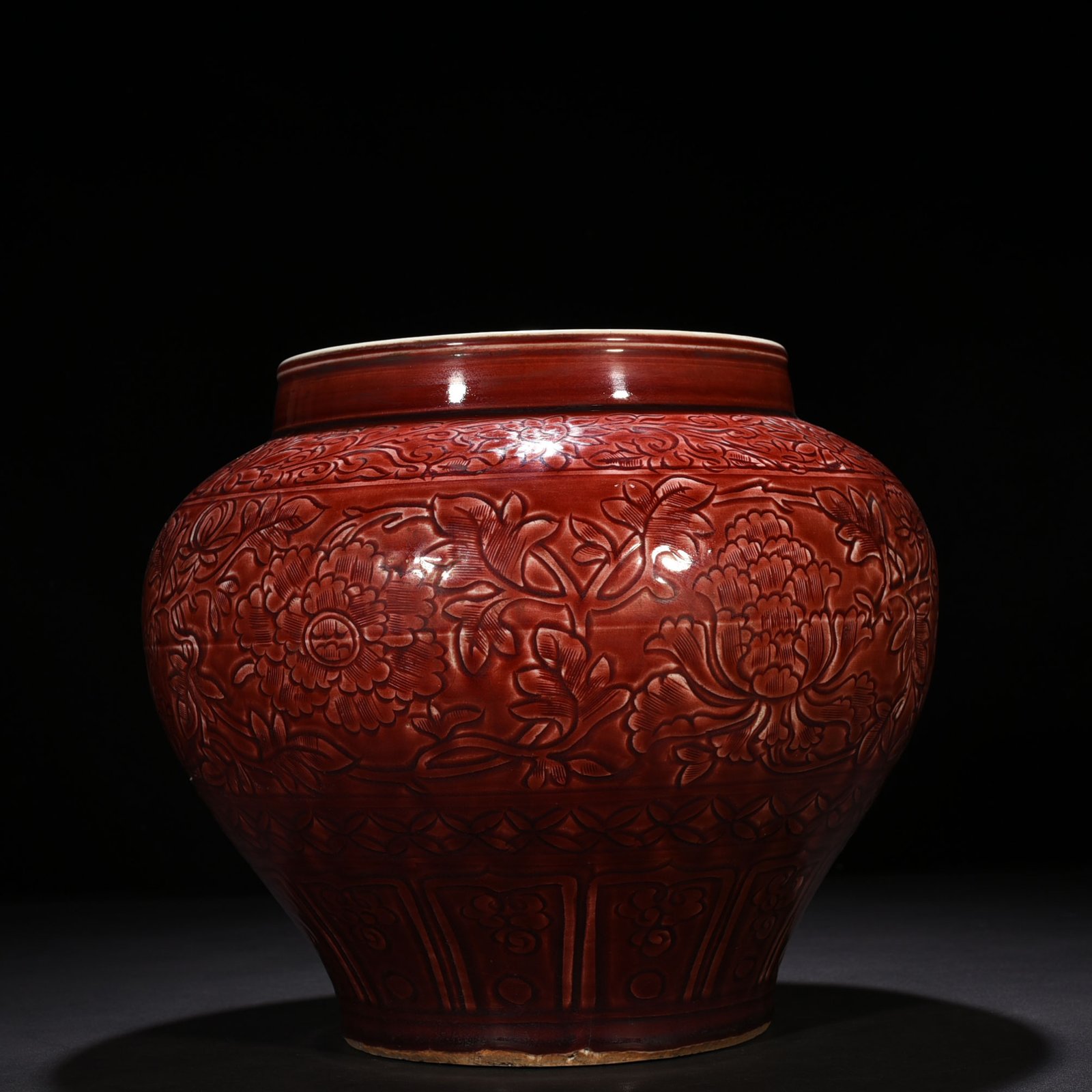 Yuan Dynasty red glaze engraved jar with peony pattern on branches