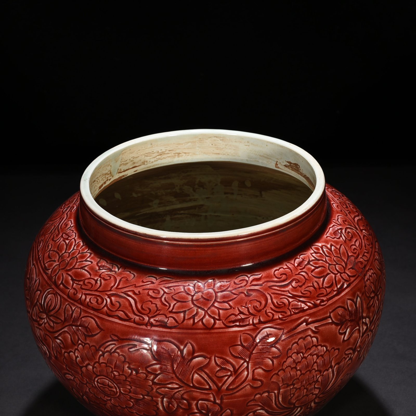 Yuan Dynasty red glaze engraved jar with peony pattern on branches