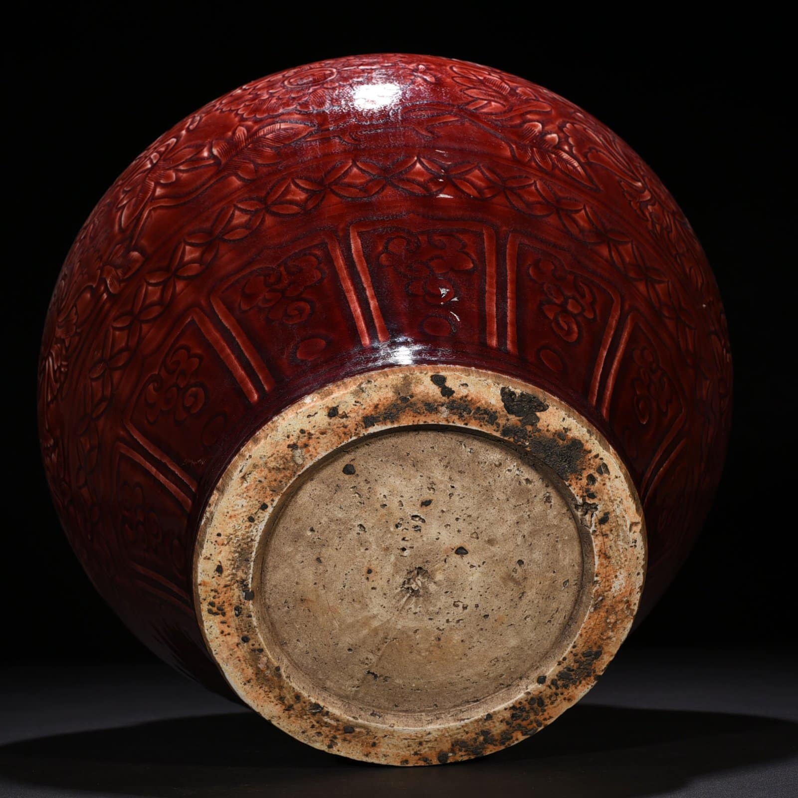 Yuan Dynasty red glaze engraved jar with peony pattern on branches