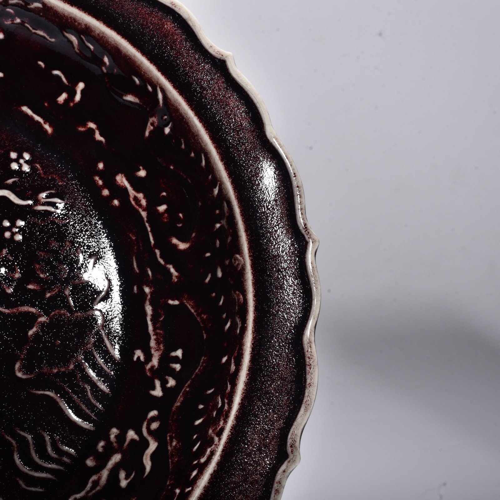 Yuan Dynasty red glaze carved cloud and dragon pattern rhombus edge plate
