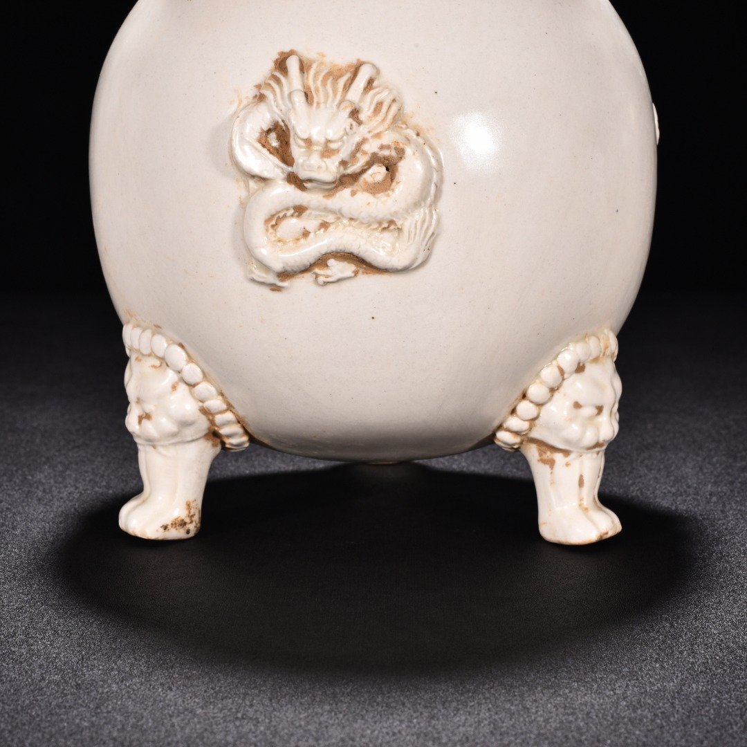 Tang Dynasty Xing kiln white porcelain laminated dragon pattern three-legged jar