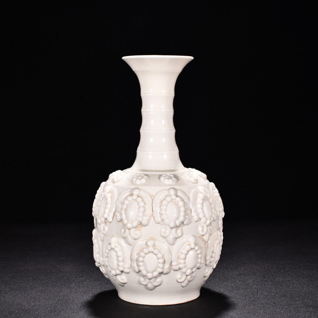Tang Dynasty Xing kiln white porcelain embossed enamel pattern bottle