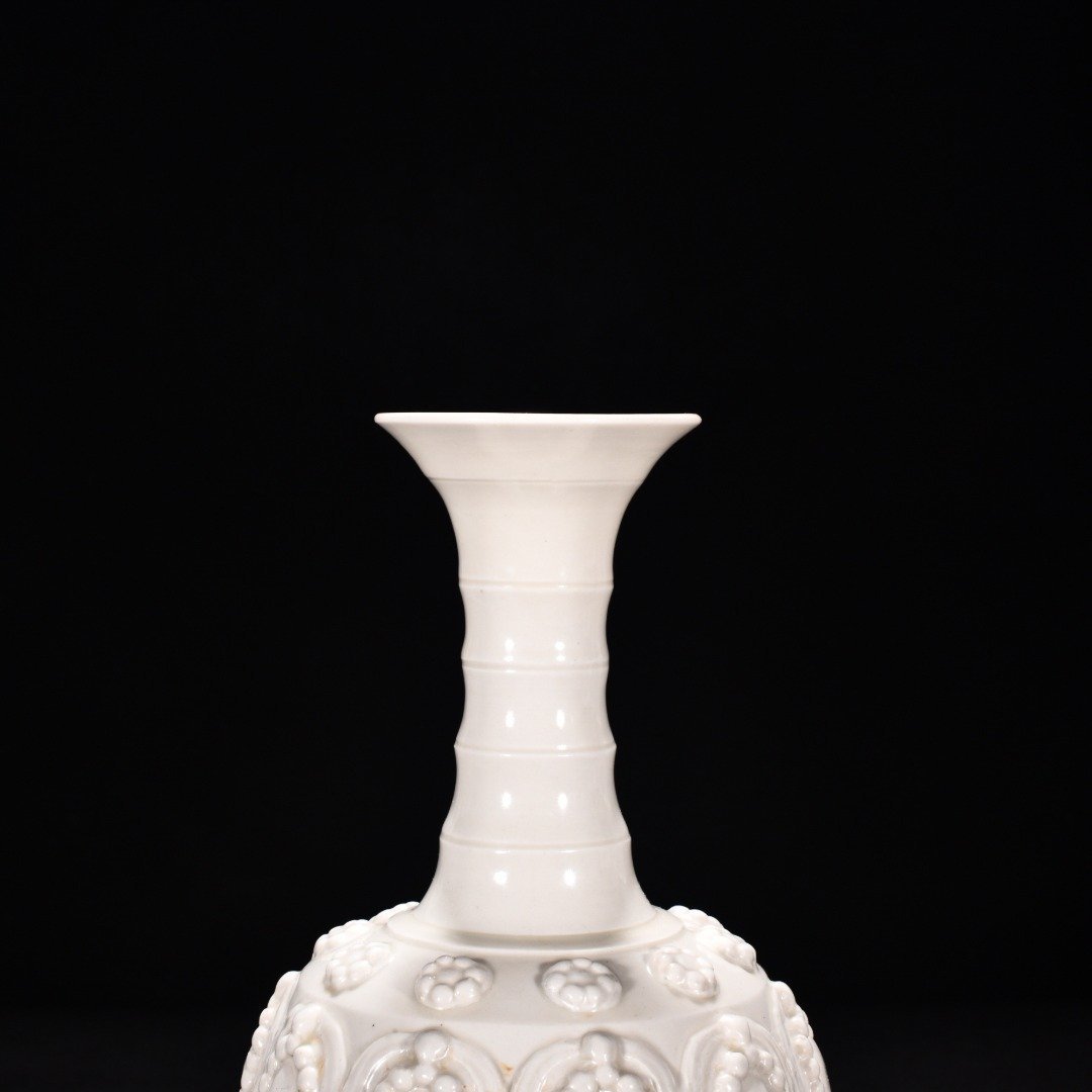 Tang Dynasty Xing kiln white porcelain embossed enamel pattern bottle
