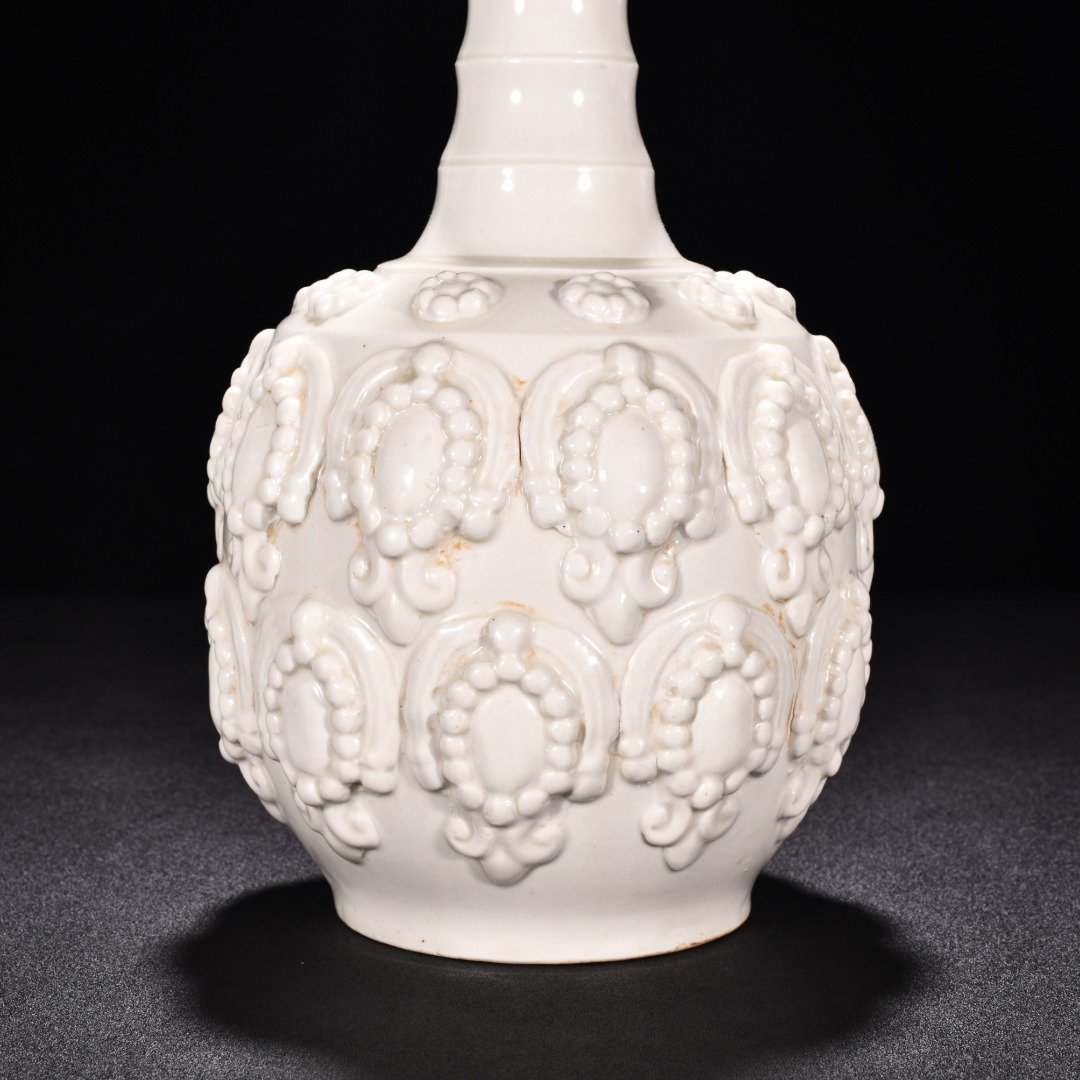 Tang Dynasty Xing kiln white porcelain embossed enamel pattern bottle
