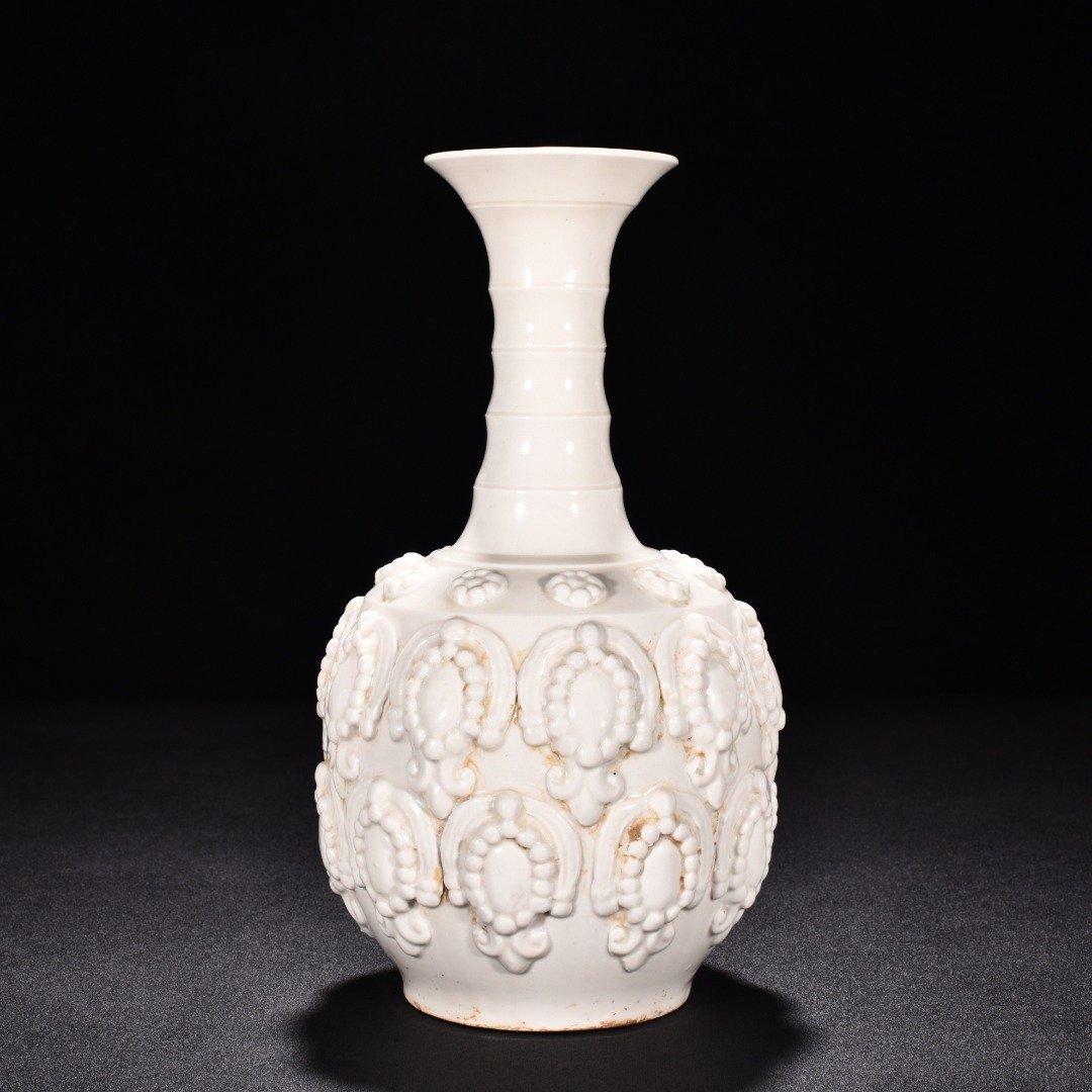 Tang Dynasty Xing kiln white porcelain embossed enamel pattern bottle