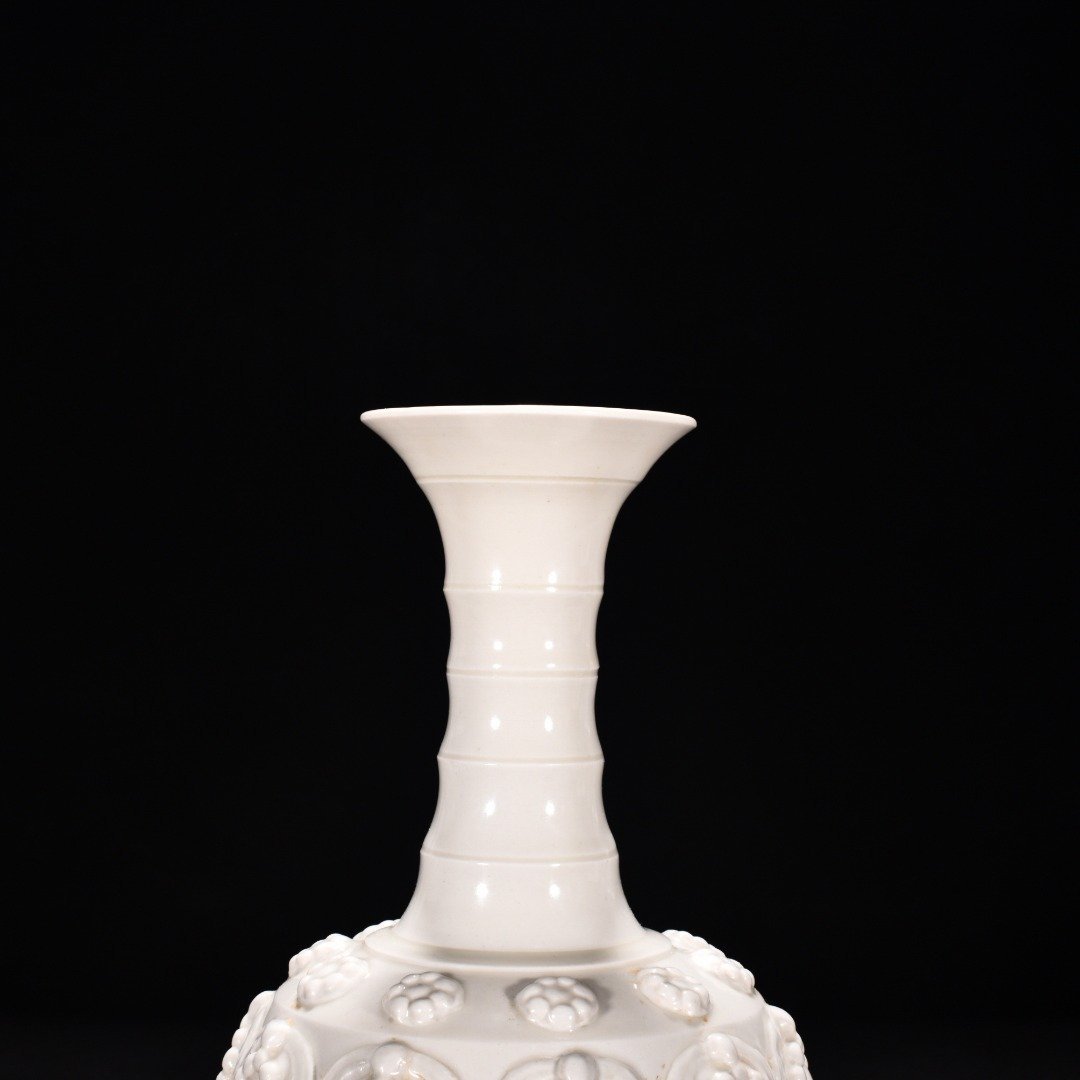 Tang Dynasty Xing kiln white porcelain embossed enamel pattern bottle