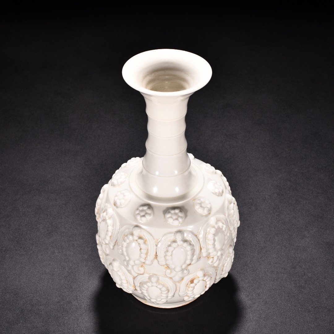 Tang Dynasty Xing kiln white porcelain embossed enamel pattern bottle
