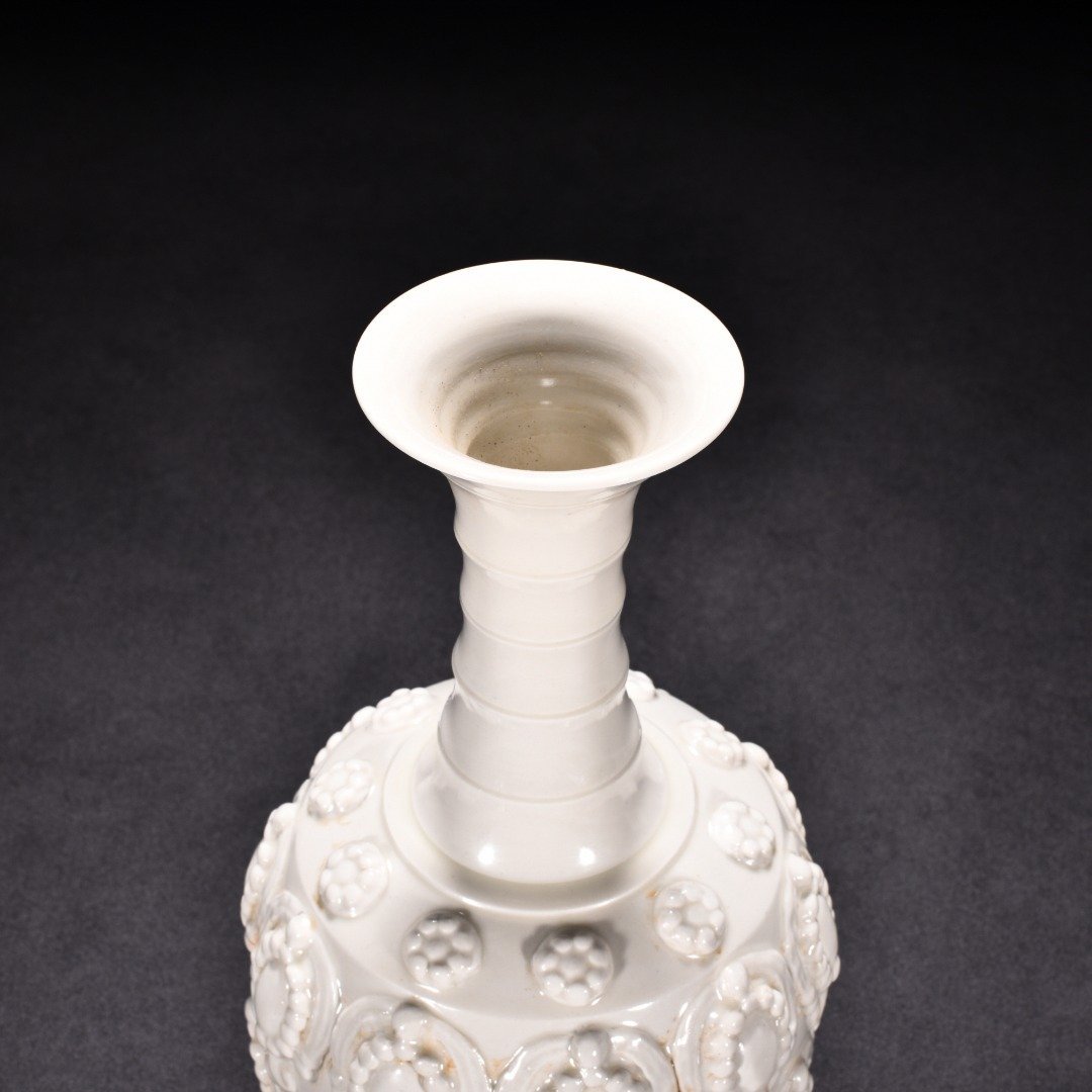 Tang Dynasty Xing kiln white porcelain embossed enamel pattern bottle