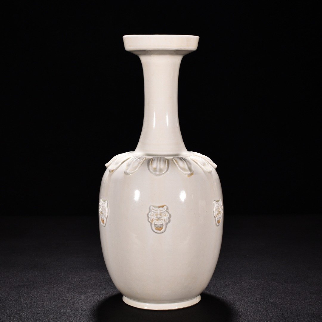 Tang Dynasty Xing kiln white porcelain laminated lotus petal animal ear disc-mouth bottle