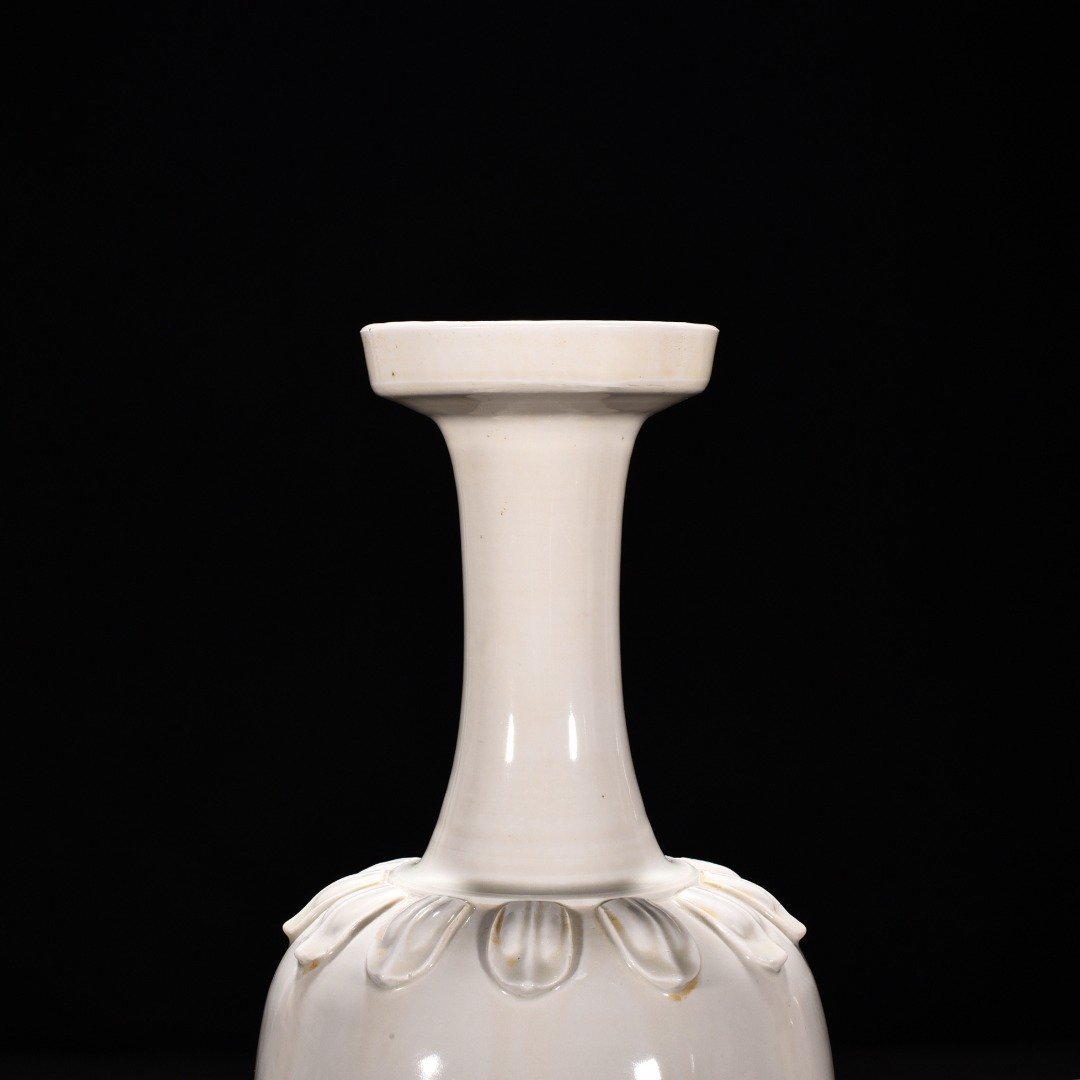 Tang Dynasty Xing kiln white porcelain laminated lotus petal animal ear disc-mouth bottle