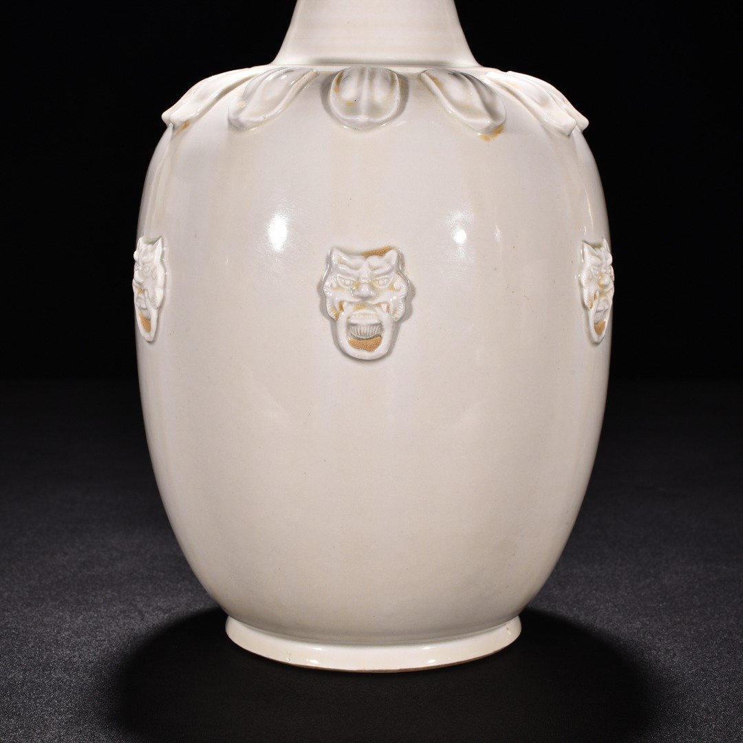 Tang Dynasty Xing kiln white porcelain laminated lotus petal animal ear disc-mouth bottle