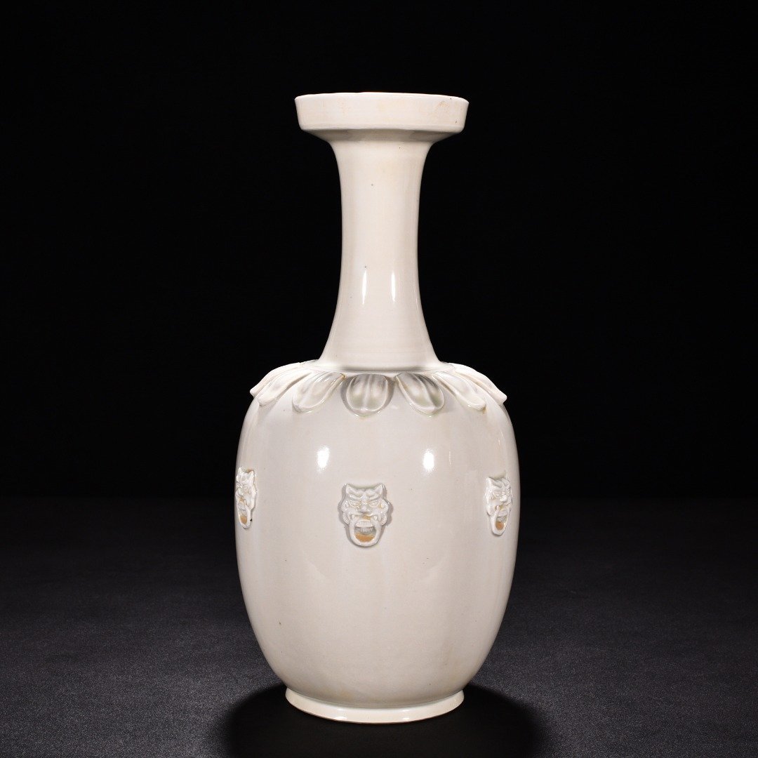 Tang Dynasty Xing kiln white porcelain laminated lotus petal animal ear disc-mouth bottle