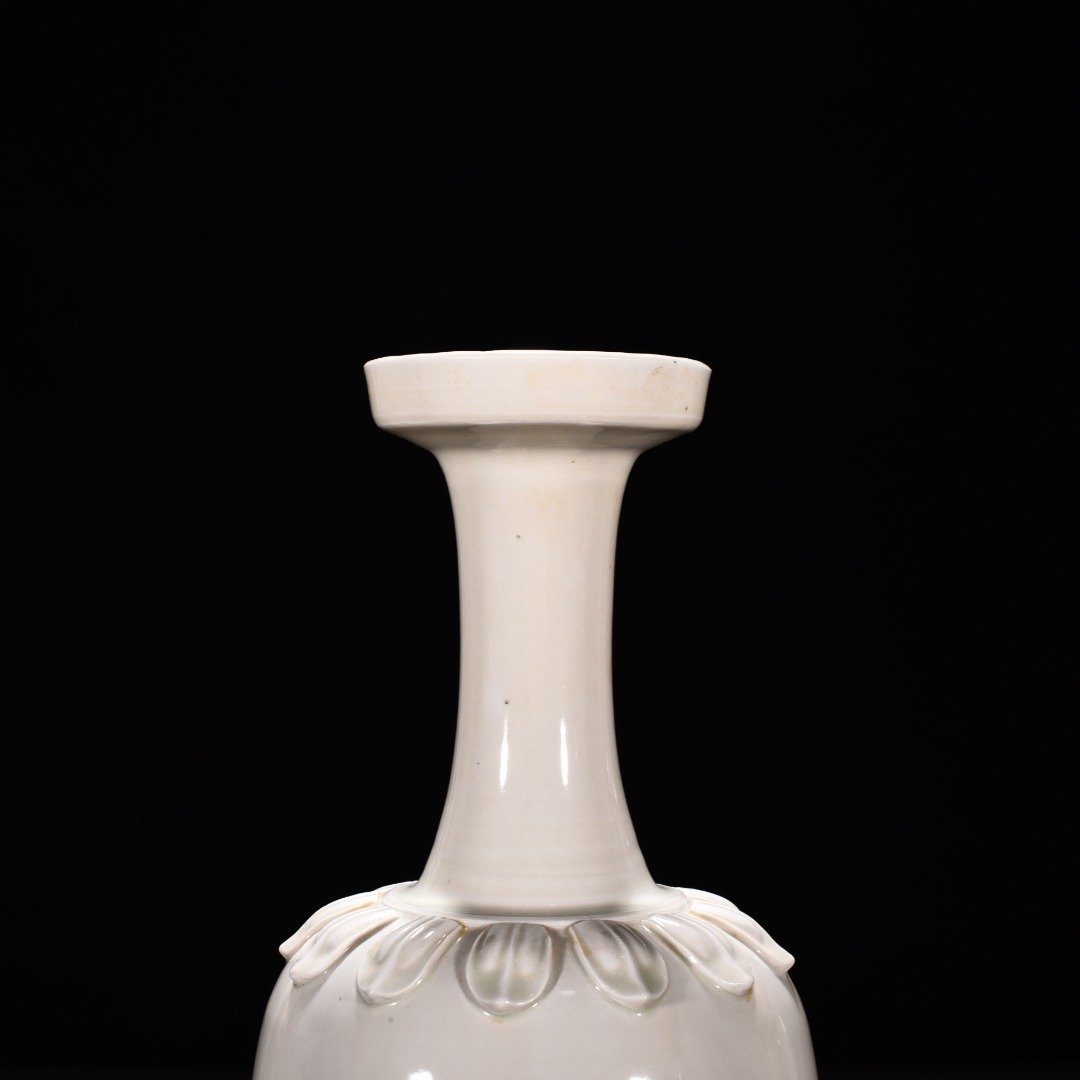 Tang Dynasty Xing kiln white porcelain laminated lotus petal animal ear disc-mouth bottle