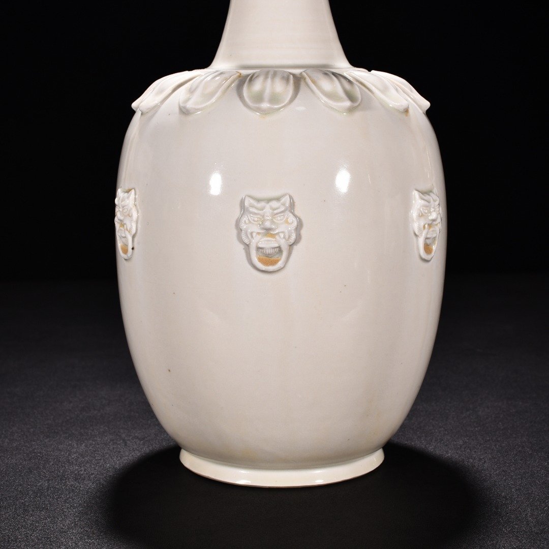 Tang Dynasty Xing kiln white porcelain laminated lotus petal animal ear disc-mouth bottle