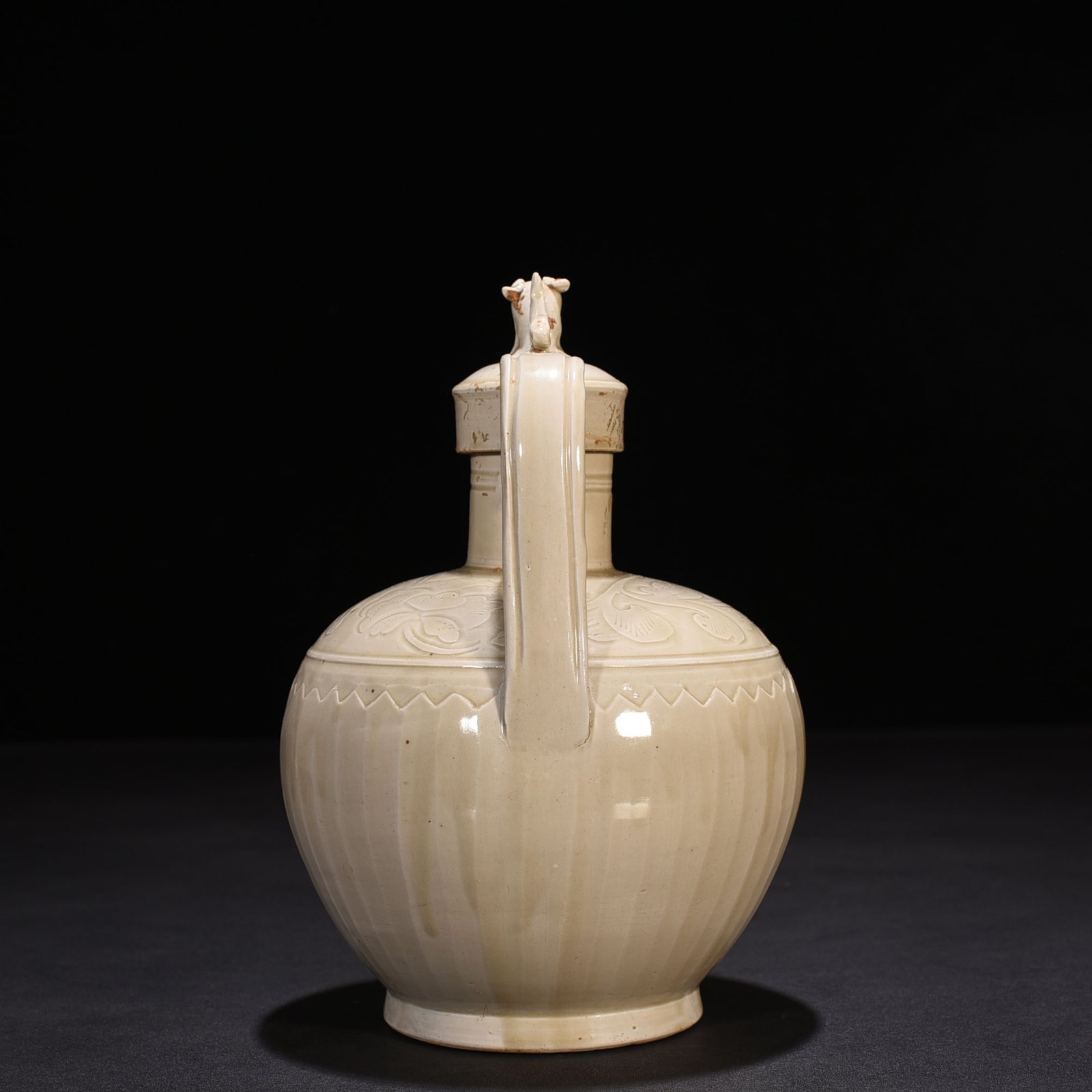 Song Dynasty Ding Kiln carved banana leaf and flower pattern ewer