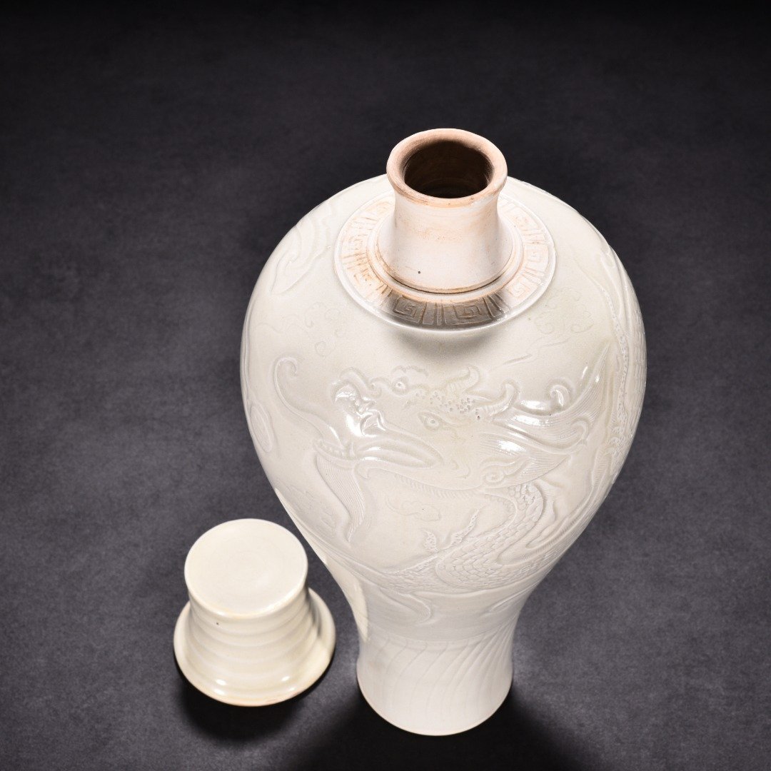 Song Dynasty Ding kiln carved plum vase with dragon pattern and lid