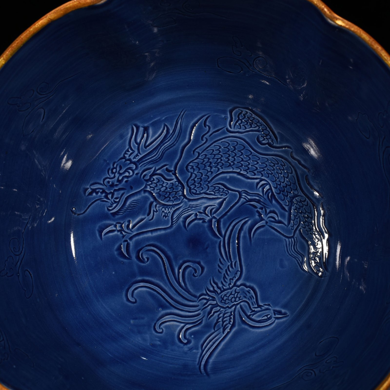 Song Dynasty Ding kiln official style blue glaze engraved dragon and phoenix bowl