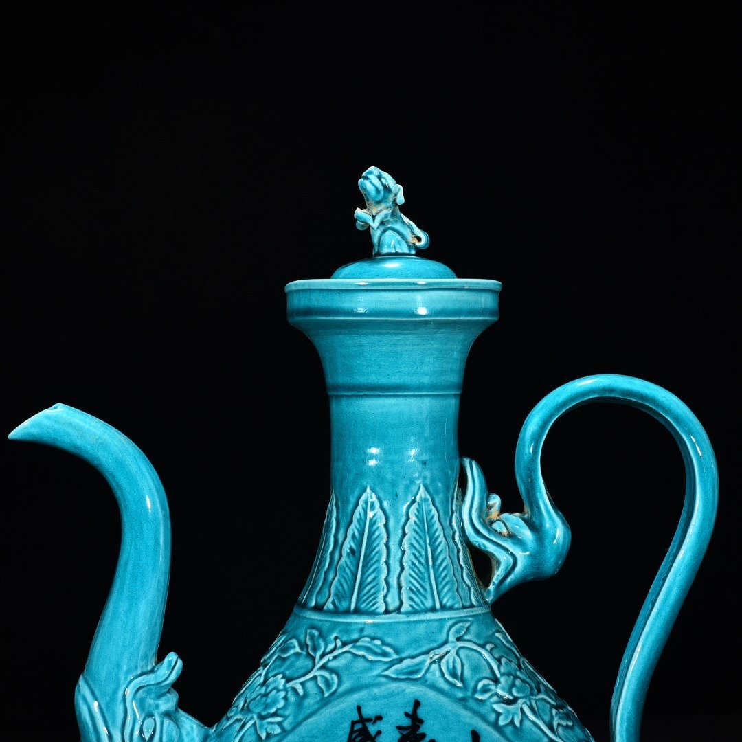 Ming Dynasty Xuande peacock blue glaze engraved flower pattern poem holding pot