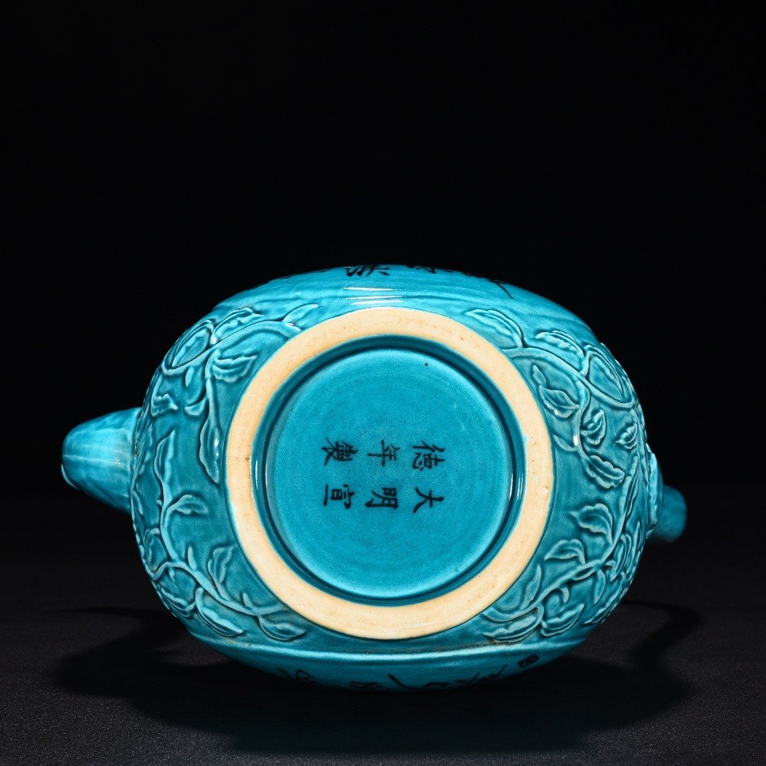 Ming Dynasty Xuande peacock blue glaze engraved flower pattern poem holding pot