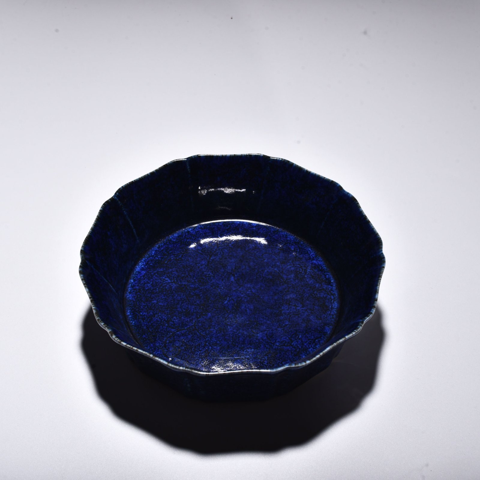 Ming Dynasty Xuande blue glaze engraved with floral pattern and ten-edge wash