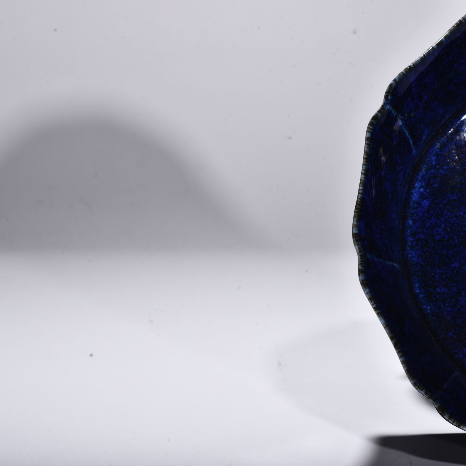 Ming Dynasty Xuande blue glaze engraved with floral pattern and ten-edge wash