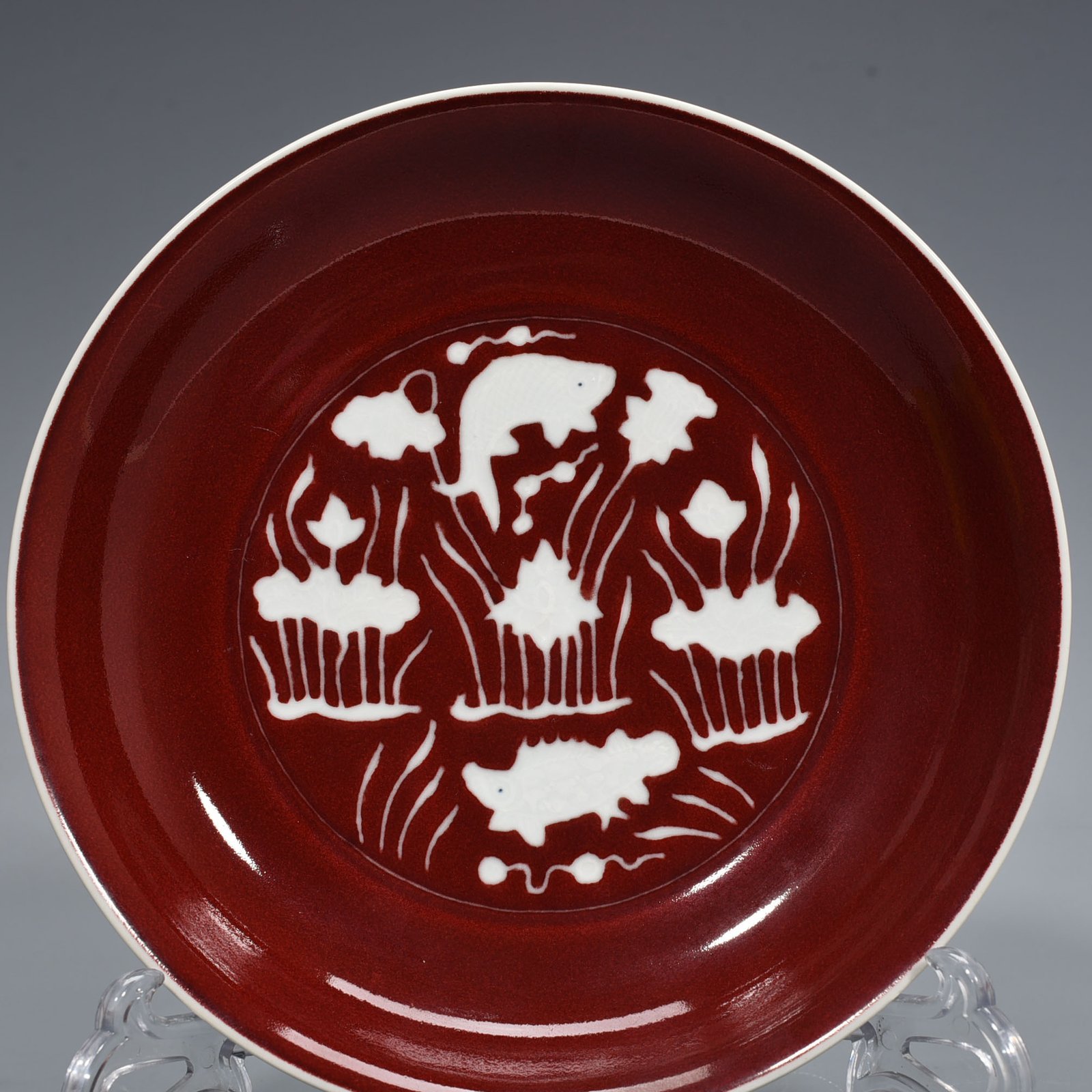 Ming Dynasty Xuande Festival red glaze engraved fish and algae pattern plate