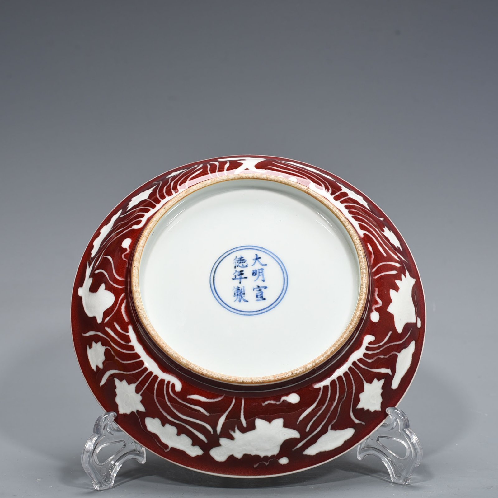 Ming Dynasty Xuande Festival red glaze engraved fish and algae pattern plate