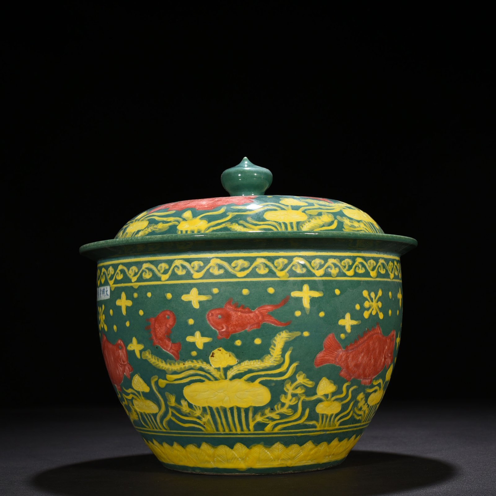 Ming Dynasty Xuande green glaze carved fish and algae pattern lid jar