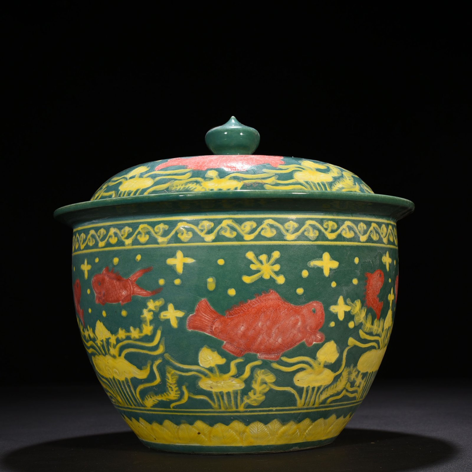 Ming Dynasty Xuande green glaze carved fish and algae pattern lid jar