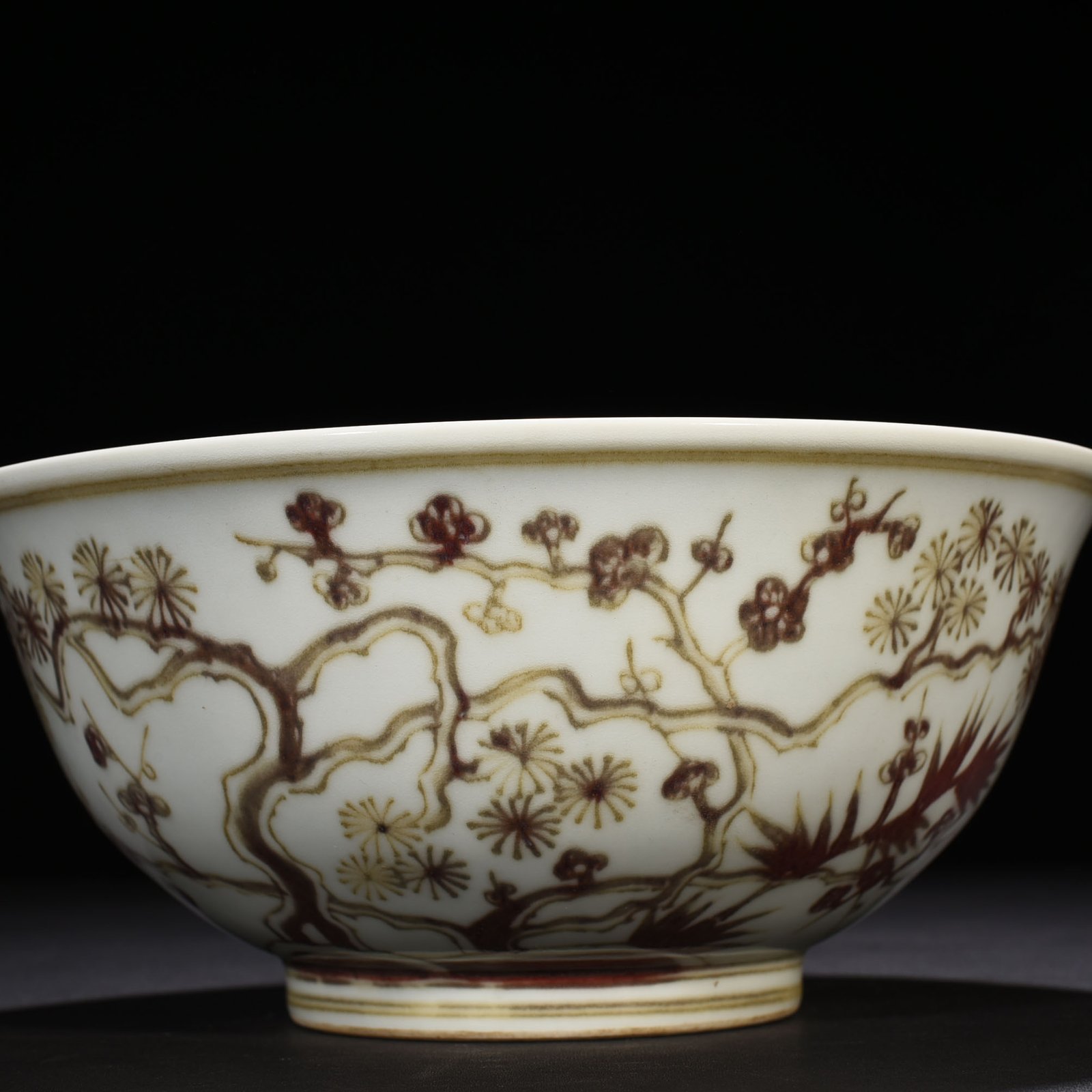 Ming Dynasty Xuande underglaze red pine bamboo and plum pattern bowl