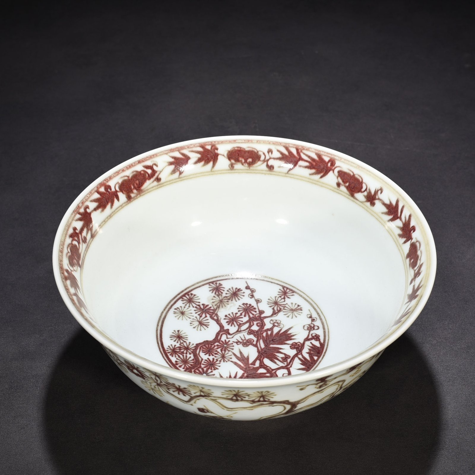 Ming Dynasty Xuande underglaze red pine bamboo and plum pattern bowl