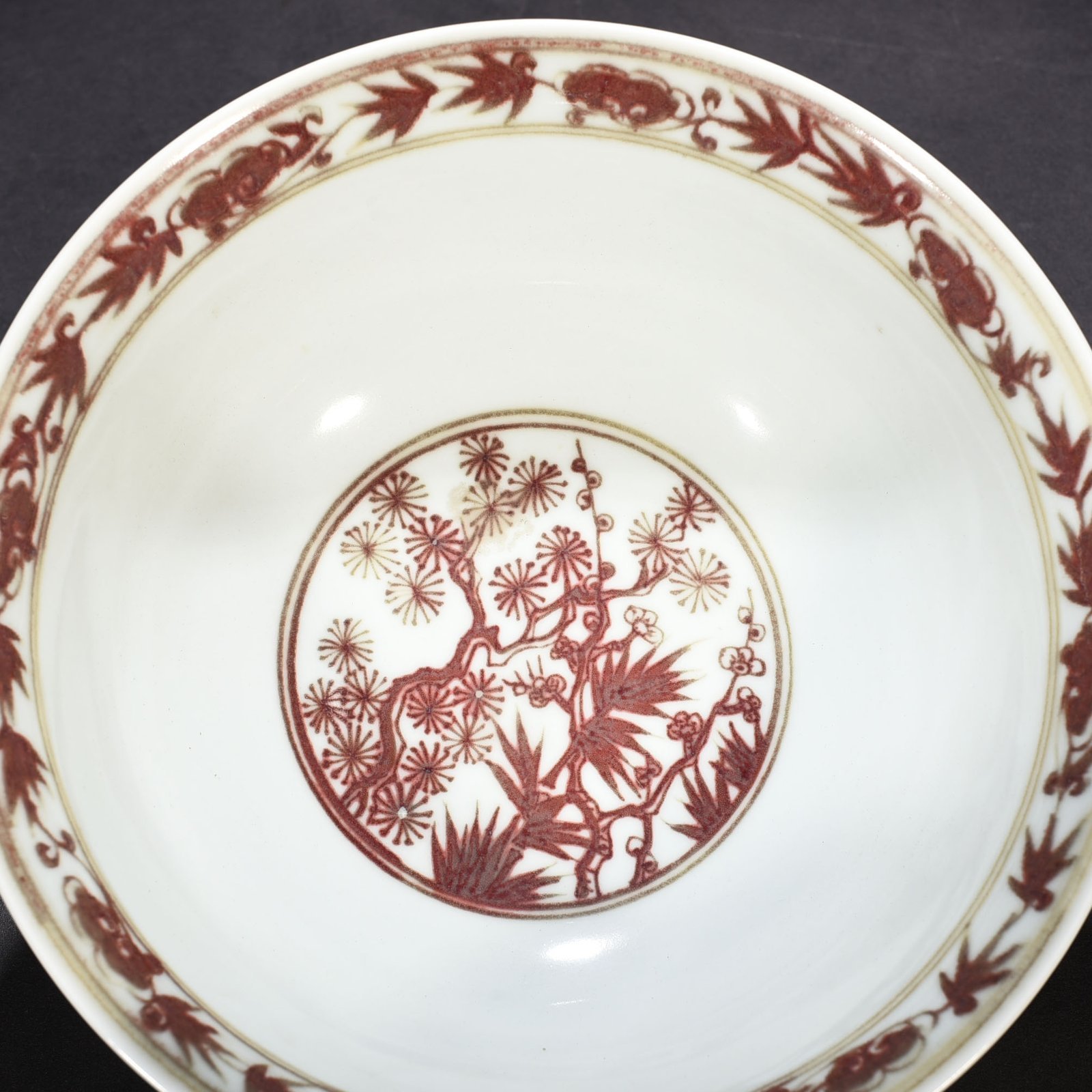 Ming Dynasty Xuande underglaze red pine bamboo and plum pattern bowl