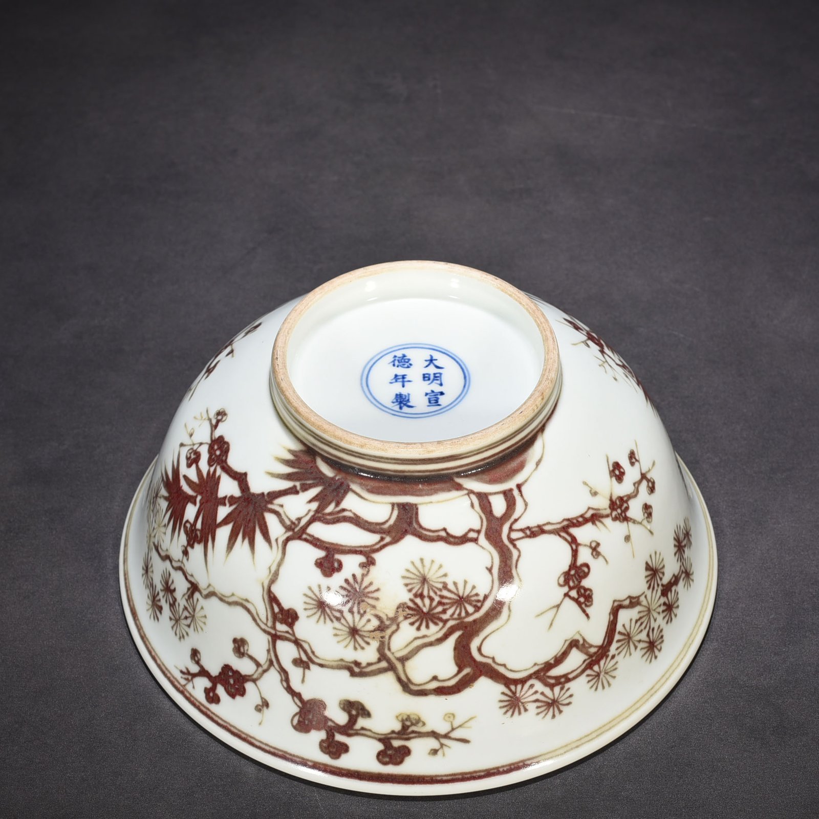 Ming Dynasty Xuande underglaze red pine bamboo and plum pattern bowl