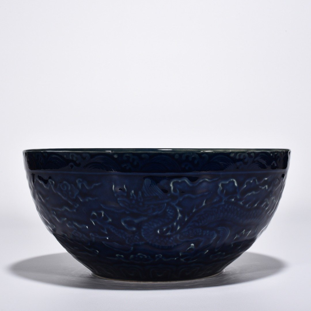 Ming Dynasty Xuande blue glaze bowl with carved cloud and dragon pattern