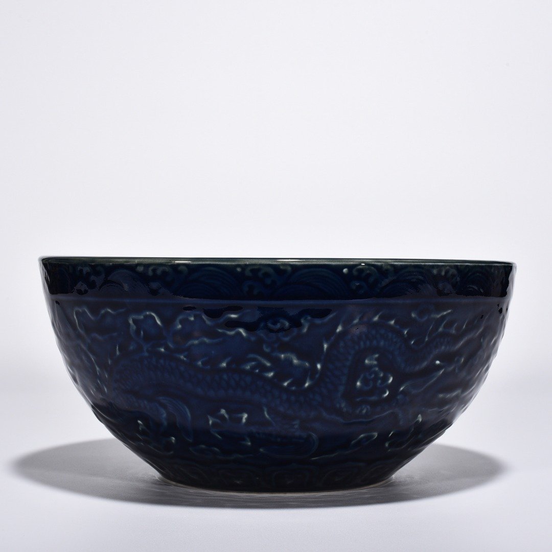 Ming Dynasty Xuande blue glaze bowl with carved cloud and dragon pattern