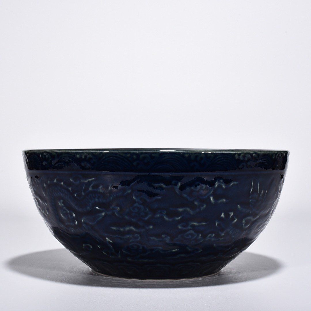 Ming Dynasty Xuande blue glaze bowl with carved cloud and dragon pattern