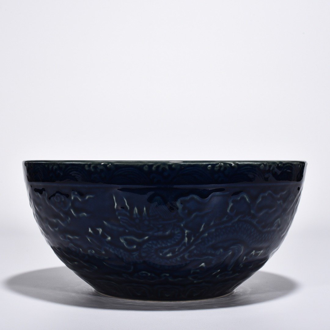 Ming Dynasty Xuande blue glaze bowl with carved cloud and dragon pattern